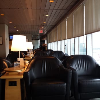 United Club - a row of black leather chairs in a lounge area - Airport Lounges Near Me - Flushing, New York United Club - a row of black leather chairs in a lounge area - Airport Lounges Near Me - Flushing, New York