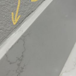 The backsplash did not reach up far enough to cover the damage to the wall from previous backsplash. A measurement issue.