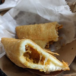 One plantain and cheese and one chicken empanada, half eaten (meaning they were twice as big originally). One plantain and cheese and one chicken empanada, half eaten (meaning they were twice as big originally).