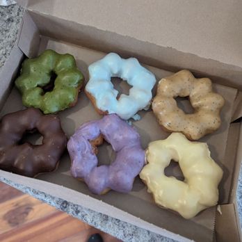 Nok's Donuts - Top: matcha, blue lemon, espresso Bottom: chocolate, ube, pineapple (maybe) - Donuts Near Me - Lafayette, Colorado Nok's Donuts - Top: matcha, blue lemon, espresso Bottom: chocolate, ube, pineapple (maybe) - Donuts Near Me - Lafayette, Colorado