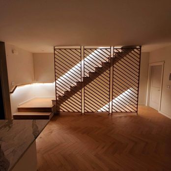 Alluvion Homes - a living room with a staircase - General Contractors Near Me