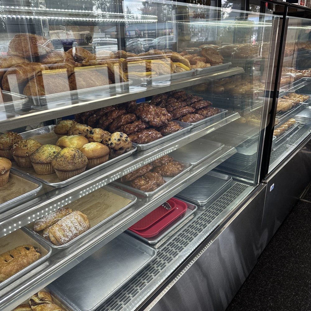 Factory Donuts - a display case filled with baked goods - Donuts Near Me - Kirkland, Washington