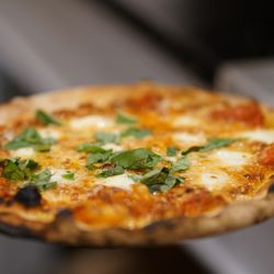 Margherita Pizza - San Gennaro - mixed sausage, wood fired red peppers & onions, mozzarella, basil, EVOO - out of this world with Mike's Hot Honey!