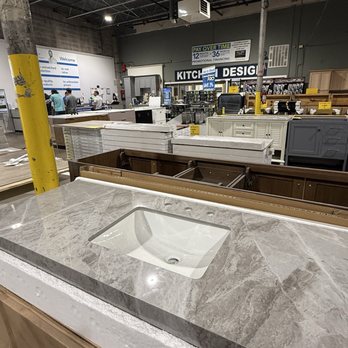 Seconds & Surplus - The counter was very busy when I stopped in. - A marble countertop with an integrated sink is shown in a warehouse store, surrounded by other cabinetry and hardware items. - Building Supplies Near Me - Richardson, Texas