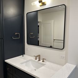 Bathroom vanity, linen cabinet and countertop sourced from Caninets 101. This beautiful navy was a stock color