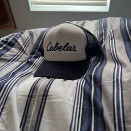 a baseball cap on a bed a baseball cap on a bed