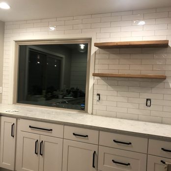 Parks Flooring - a kitchen with white cabinets and a large mirror - General Contractors Near Me Parks Flooring - a kitchen with white cabinets and a large mirror - General Contractors Near Me