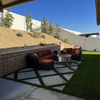 Re-Leaf Landscape - After, backyard. Concrete design with turf and California gold rock on slope with all new plants. - Landscaping Near Me - Winchester, California