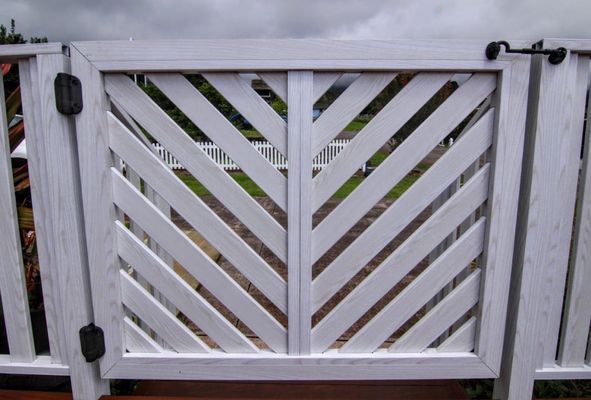 Photo of Defensible Designs - Orinda, CA, US. Sample of "Knotwood" aluminum product on a gate