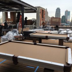 Action billiard service - All weather pool tables overlooking Kansas City skyline