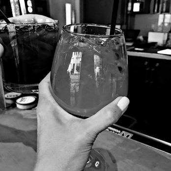 Latitude Lounge - a person holding a glass of wine - Lounges Near Me - San Diego, California Latitude Lounge - a person holding a glass of wine - Lounges Near Me - San Diego, California