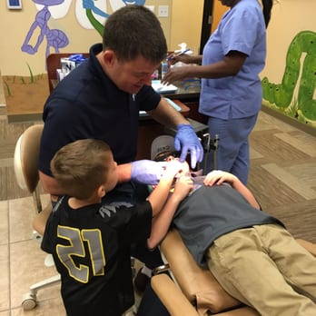 Anthem Pediatric Dentistry & Orthodontics - Little brother assisting Dr. - Pediatric Dentists Near Me - Henderson, Nevada Anthem Pediatric Dentistry & Orthodontics - Little brother assisting Dr. - Pediatric Dentists Near Me - Henderson, Nevada
