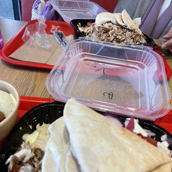 Boustan - a woman eating a meal at a restaurant - Middle Eastern Near Me - Toronto, Ontario