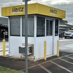 Hertz Rent A Car - Back side of the booth where you leave the lot.