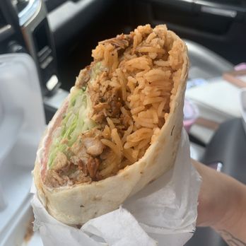 Tamaulipas - a person holding a burrito - Food Stands Near Me - Irving, Texas