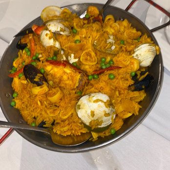 O Lavrador - a pan of food on a table - Portuguese Near Me - Jamaica, New York O Lavrador - a pan of food on a table - Portuguese Near Me - Jamaica, New York