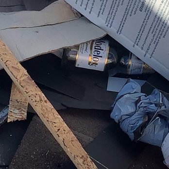 DaBella - Empty beer bottles in the dumpster with the roof roofing material. - Windows Installation Near Me - Reno, Nevada