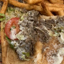 Manhattan Pizza - Sparse cheesesteak with a single miniature tomato, brown lettuce and very little meat.