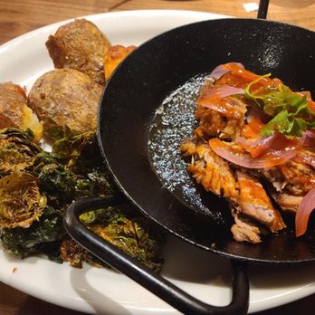 Tupelo Honey - Cast Iron Pork ($16.95), really unique dish with crispy brussels & potato cracklins! - Southern Near Me - Franklin, Tennessee Tupelo Honey - Cast Iron Pork ($16.95), really unique dish with crispy brussels & potato cracklins! - Southern Near Me - Franklin, Tennessee