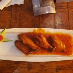 Pat'e Palo Bar & Grill - Wings covered in signature chili sauce.