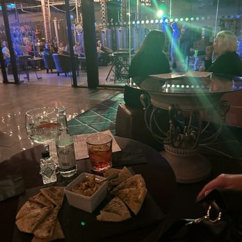 Reid's Distillery - Pita and hummus, classic gin and tonic, blood orange negroni with a live band in background - Distilleries Near Me - Toronto, Ontario