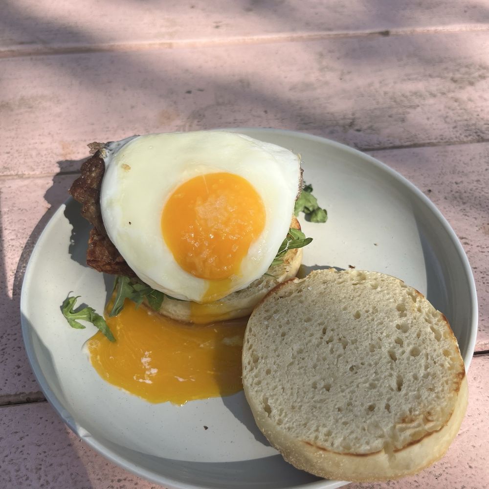 Better Half Coffee & Cocktails - Breakfast sandwich with breakfast sausage and a beautiful runny egg - Cafes Near Me - Austin, Texas Better Half Coffee & Cocktails - Breakfast sandwich with breakfast sausage and a beautiful runny egg - Cafes Near Me - Austin, Texas