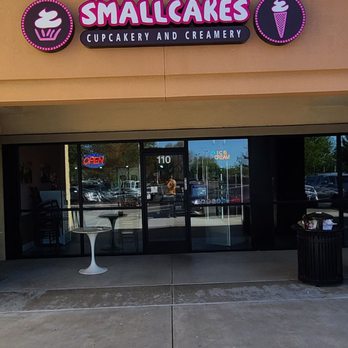 Smallcakes Cupcakery - Smallcakes Cupcakery and Creamery storefront features a pink sign with ice cream icons and the business name, with glass doors and an 'OPEN' sign. - Cupcakes Near Me - Ripon, California