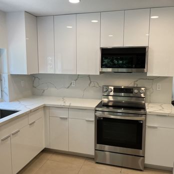 ASB Construction Group - Here is a photo of a kitchen we remodeled with European style frameless flat panel cabinets with a quartz countertop with full backsplash. - General Contractors Near Me ASB Construction Group - Here is a photo of a kitchen we remodeled with European style frameless flat panel cabinets with a quartz countertop with full backsplash. - General Contractors Near Me