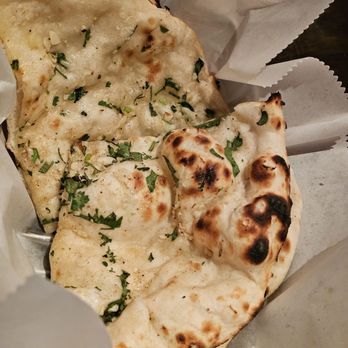 Nawab Indian Cuisine - The Garlic Naan in a basket. - Indian Near Me - Roanoke, Virginia Nawab Indian Cuisine - The Garlic Naan in a basket. - Indian Near Me - Roanoke, Virginia