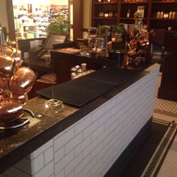 a counter with copper pots and pans on it