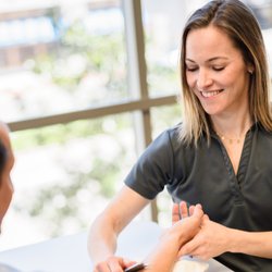 Select Physical Therapy - Glastonbury - Therapist using the IASTM technique to a patient