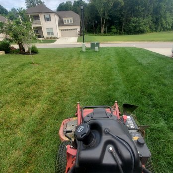 Zelmor Landscaping - a lawn mower in a residential area - Lawn Services Near Me