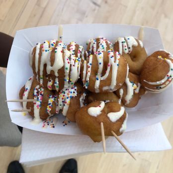Mini Donut Factory - a person holding a tray of mini donuts - Donuts Near Me - Gurnee, Illinois Mini Donut Factory - a person holding a tray of mini donuts - Donuts Near Me - Gurnee, Illinois