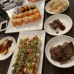 Torched sushis, salmon roses, sashimi, garlic shrimp, teriyaki salmon Torched sushis, salmon roses, sashimi, garlic shrimp, teriyaki salmon