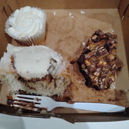 A cinnamon roll, cupcake and brownie A cinnamon roll, cupcake and brownie