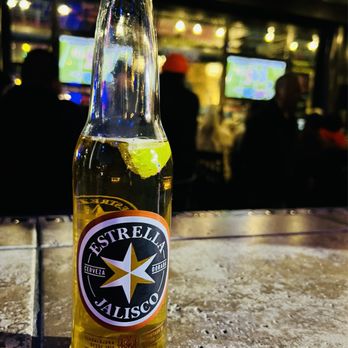 Bishop Exchange - a bottle of beer on a table - Bars Near Me - Dallas, Texas