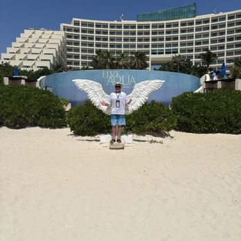 Live Aqua Resort - Me standing in front of the Eagles wings on the beach in front of the Live Aqua Resort . - Resorts Near Me - Cancún, ROO