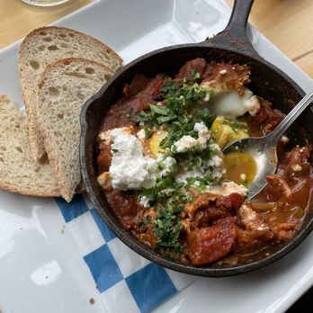 Nom Cafe - shakshuka with poached eggs and sourdough toast - Modern European Near Me - Portland, Maine