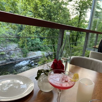 Siena Ristorante Norwalk - a woman sitting at a table overlooking a river - Italian Near Me - Norwalk, Connecticut Siena Ristorante Norwalk - a woman sitting at a table overlooking a river - Italian Near Me - Norwalk, Connecticut