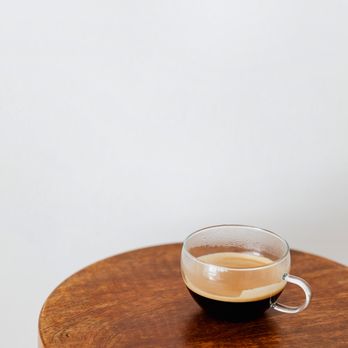 Model Bean Coffee Co - a cup of coffee on a table - Coffee & Tea Near Me - Kelowna, British Columbia Model Bean Coffee Co - a cup of coffee on a table - Coffee & Tea Near Me - Kelowna, British Columbia