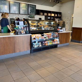 Starbucks - a woman standing at the counter of a coffee shop - Coffee & Tea Near Me - Belfair, Washington Starbucks - a woman standing at the counter of a coffee shop - Coffee & Tea Near Me - Belfair, Washington