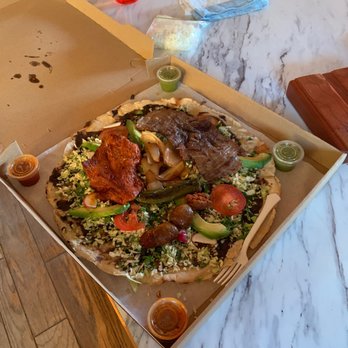 Taqueria Oaxaca - a pizza in a box on a table - Tacos Near Me - Kennewick, Washington Taqueria Oaxaca - a pizza in a box on a table - Tacos Near Me - Kennewick, Washington