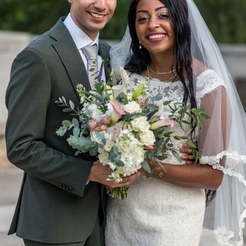 The Enchanted Florist - A newly married couple holding a bouquet - Florists Near Me - Austin, Texas The Enchanted Florist - A newly married couple holding a bouquet - Florists Near Me - Austin, Texas