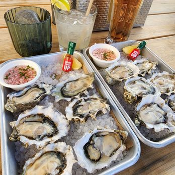 The Yard at Saltbreaker - What??? Ordered a dozen oyster and got 2 plateSof 6?? Tequila, pomegranate cider and a glass of rocks in the background. Glass of rocks????? - Cocktail Bars Near Me - Alameda, California The Yard at Saltbreaker - What??? Ordered a dozen oyster and got 2 plateSof 6?? Tequila, pomegranate cider and a glass of rocks in the background. Glass of rocks????? - Cocktail Bars Near Me - Alameda, California