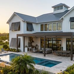 ASC Aluminum - Impact Windows, Bahama Shutters, and a covered patio on a home by ASC Aluminum.