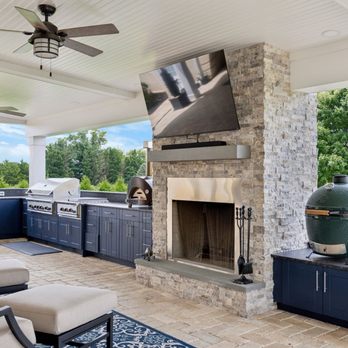 First State Building & Design - Beautiful outdoor kitchen with fireplace, premium grill, Big Green Egg grill, refrigerator, wine cooler and mounted television. - General Contractors Near Me - Chadds Ford, Pennsylvania First State Building & Design - Beautiful outdoor kitchen with fireplace, premium grill, Big Green Egg grill, refrigerator, wine cooler and mounted television. - General Contractors Near Me - Chadds Ford, Pennsylvania