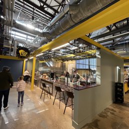 the inside of a restaurant with people walking around