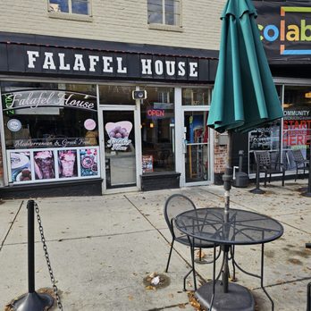 Falafel House - The outside of the restaurant with some tables and chairs for outdoor seating in the nice weather. - Falafel Near Me - Roanoke, Virginia