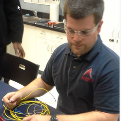 ATA College - Student working in the fiber optics laboratory.