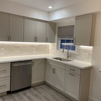 Patkowski Construction - a kitchen with a sink and dishwasher - Flooring Near Me